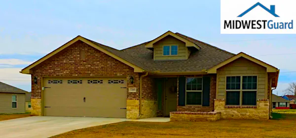 Custom 6-inch seamless gutter system with leaf guards and downspouts installed for foundation protection in Joplin, MO by MIDWESTGuard.