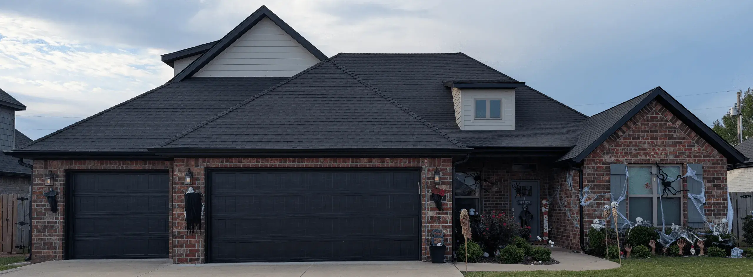 Complete exterior restoration in Springdale AR showing new roof, siding, gutter, and garage door repair by MIDWESTGuard llc.